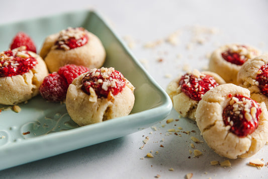 keto shortbread thumbprint cookies filled with raspberry jam and slice almonds