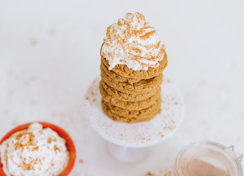 Stack of Keto Pumpkin Spice Cookies Topped with Whipped Cream and Pumpkin Spice