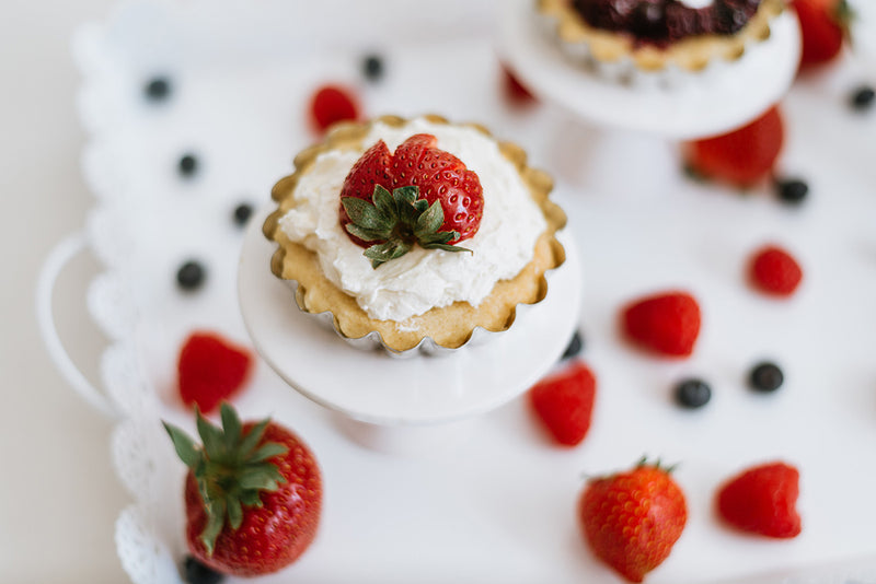 Keto Butter Cookie Tarts Topped with Whipped Cream, Strawberries, and Blueberries
