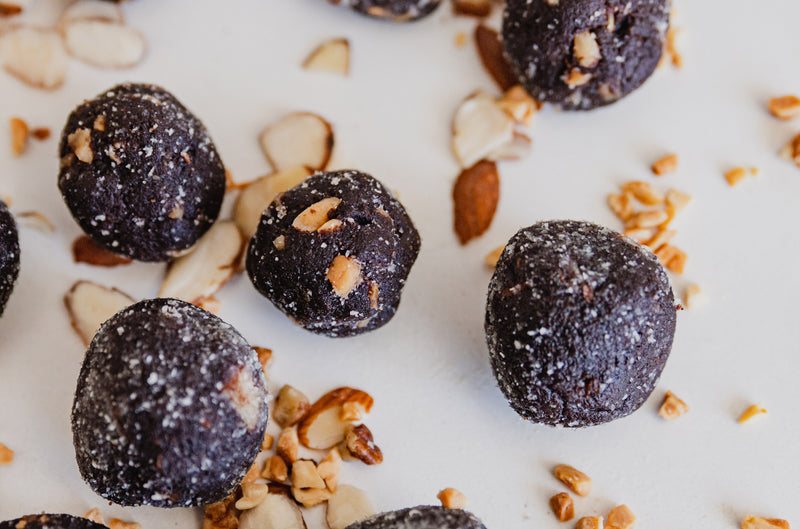Kitchen Counter with Peanut Butter Chocolate Keto No Bake Energy Bite Fat Bombs with Chopped Nuts
